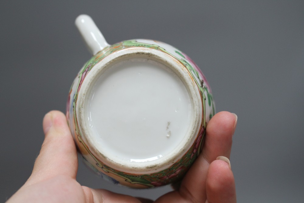 A small Cantonese porcelain teapot, a Satsuma vase, a silkwork panel, a doll and a broken soapstone figure